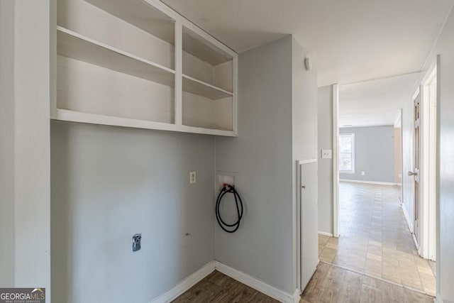 clothes washing area featuring washer hookup and light hardwood / wood-style floors