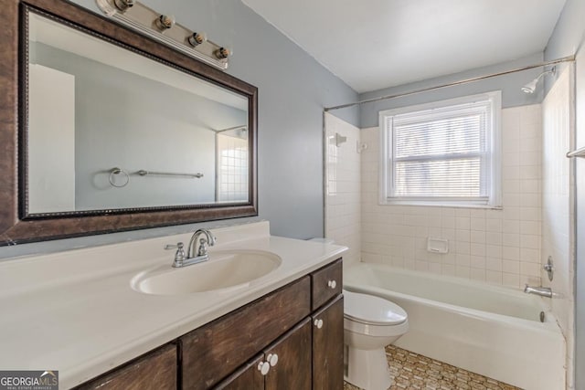 full bathroom with vanity, toilet, and tiled shower / bath combo