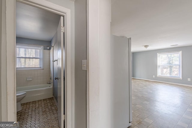 bathroom featuring plenty of natural light and toilet