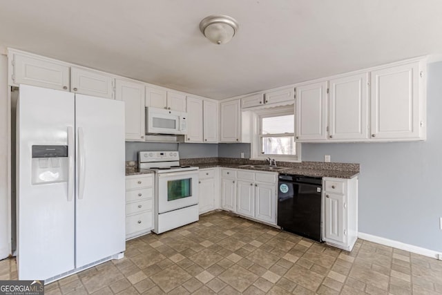 kitchen featuring white cabinetry, sink, and white appliances