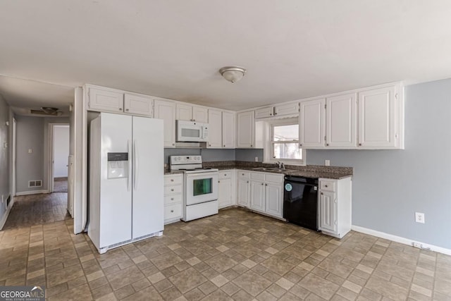 kitchen featuring white appliances, white cabinetry, and sink