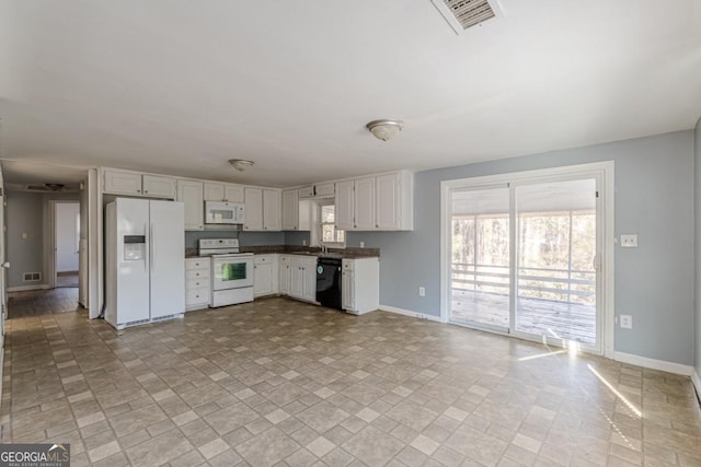 kitchen featuring white cabinets and white appliances