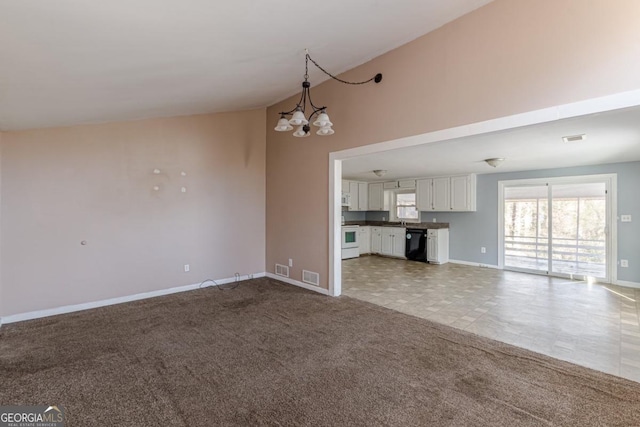 unfurnished living room with light carpet, sink, and a notable chandelier