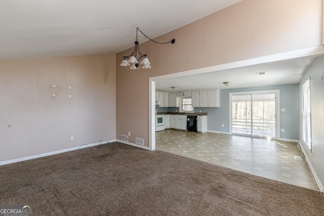 unfurnished living room featuring light colored carpet and an inviting chandelier