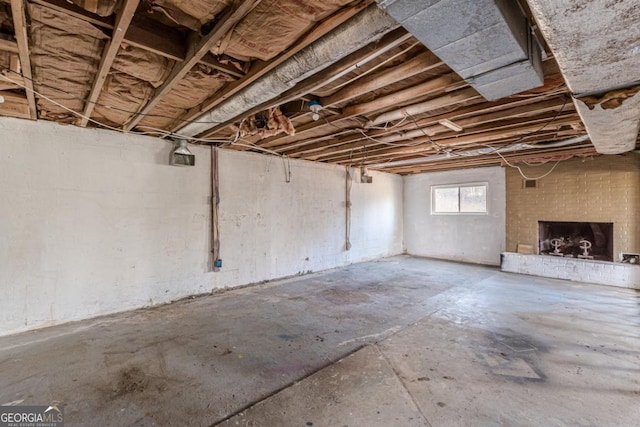 basement with a brick fireplace