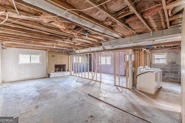 basement featuring a wealth of natural light and independent washer and dryer