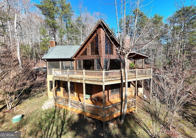 back of house with a wooden deck