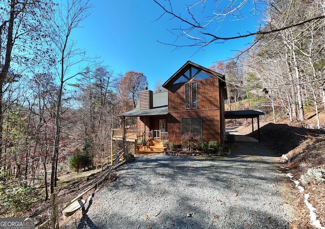 view of side of property featuring a porch and a carport