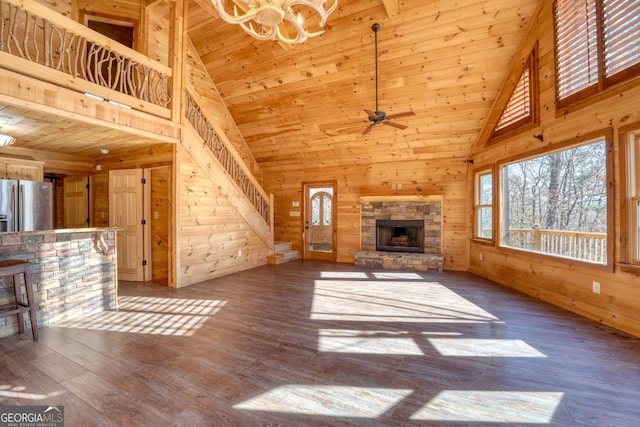 unfurnished living room with hardwood / wood-style floors, a fireplace, high vaulted ceiling, and wood ceiling