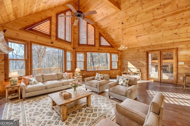 living room featuring high vaulted ceiling, ceiling fan with notable chandelier, beam ceiling, light hardwood / wood-style floors, and wood ceiling