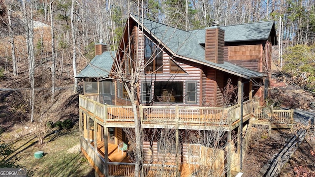 view of front of home featuring a sunroom and a wooden deck