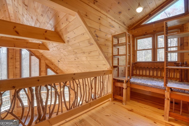 additional living space featuring lofted ceiling, hardwood / wood-style flooring, wood walls, and wood ceiling