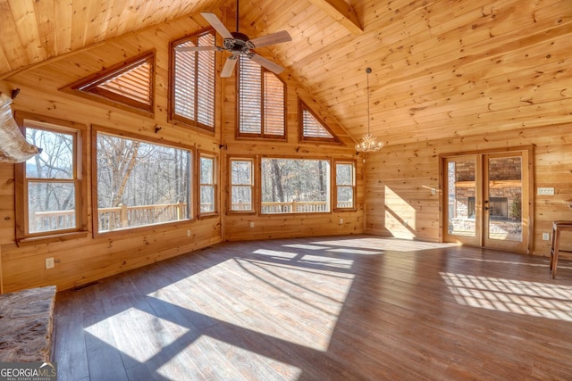 unfurnished living room with beamed ceiling, plenty of natural light, wooden ceiling, and high vaulted ceiling