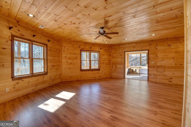 empty room featuring ceiling fan, wood ceiling, and light hardwood / wood-style floors