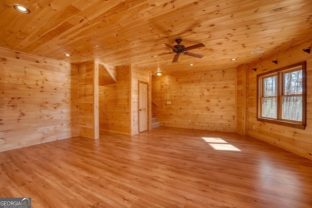 additional living space featuring ceiling fan, wood ceiling, wood walls, and light wood-type flooring