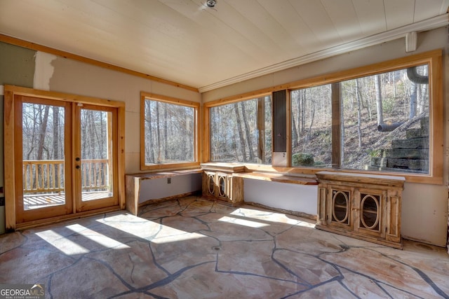 unfurnished sunroom featuring a wealth of natural light and french doors