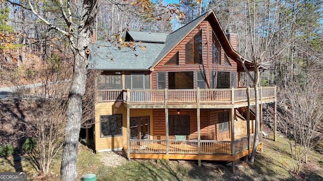 rear view of house featuring a deck