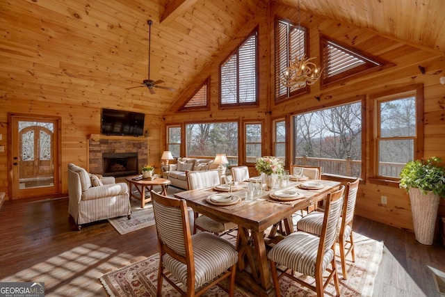 dining room with a fireplace, hardwood / wood-style floors, high vaulted ceiling, and ceiling fan