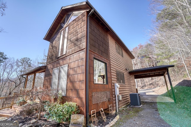 view of side of property featuring central AC