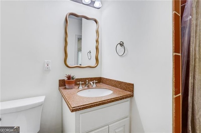 bathroom featuring toilet and vanity