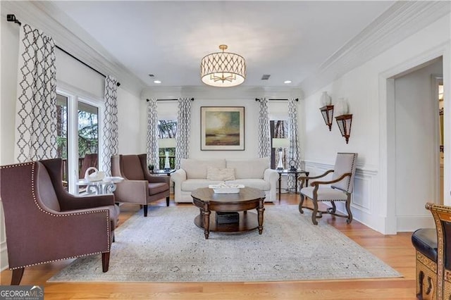 living room featuring wood-type flooring and crown molding