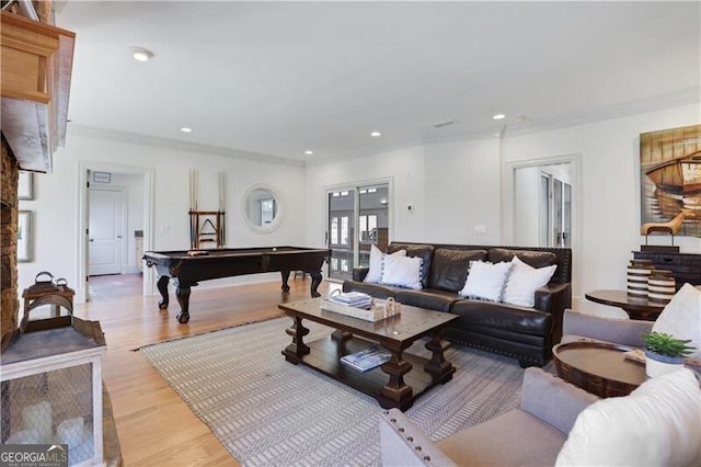 living room with pool table, light hardwood / wood-style flooring, and ornamental molding