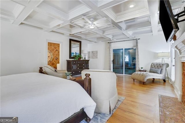 bedroom with beam ceiling, light hardwood / wood-style floors, access to outside, and coffered ceiling