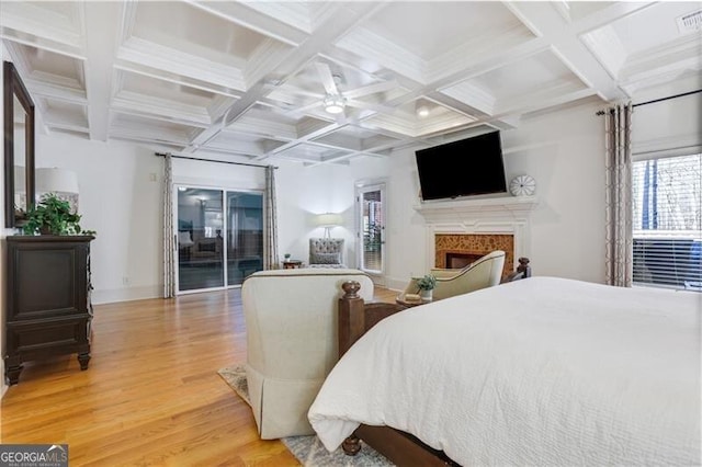 bedroom with hardwood / wood-style floors, access to exterior, ceiling fan, beam ceiling, and coffered ceiling