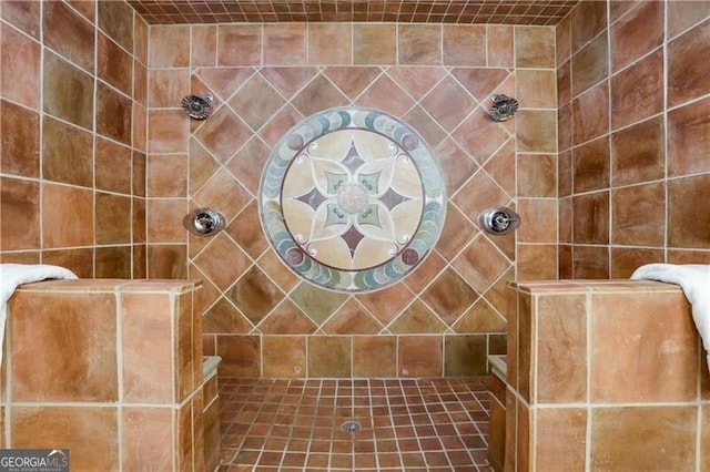 bathroom with a tile shower