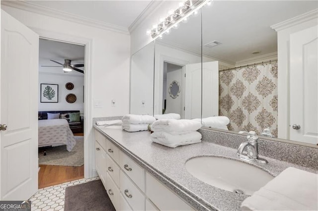 bathroom featuring wood-type flooring, vanity, walk in shower, ornamental molding, and ceiling fan