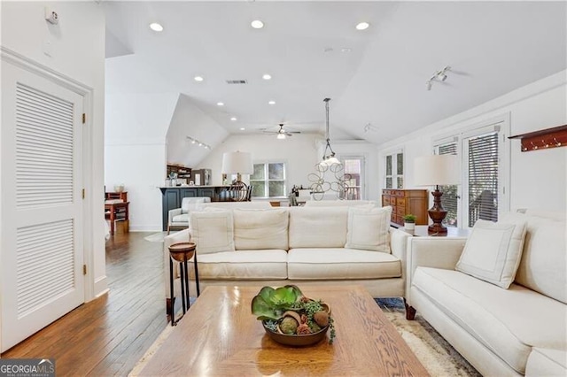 living room featuring ceiling fan, lofted ceiling, and dark hardwood / wood-style floors