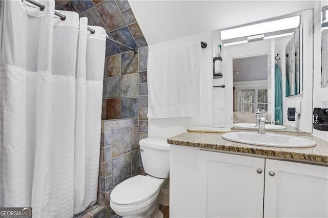 bathroom featuring tile walls, toilet, and vanity