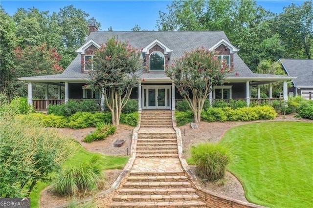 farmhouse-style home featuring a front lawn and french doors