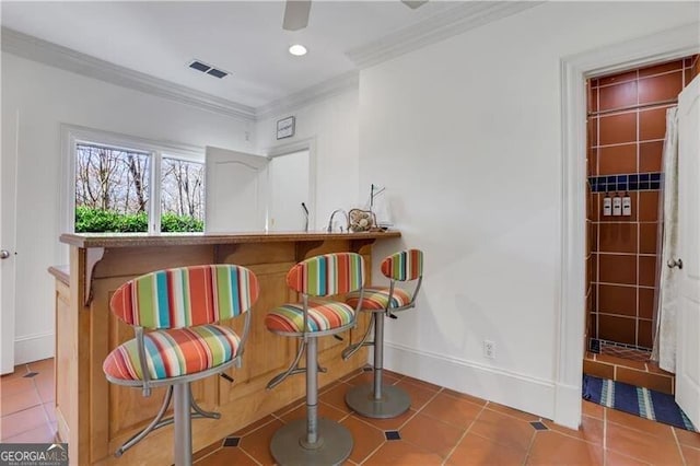 sitting room featuring tile patterned floors and ornamental molding