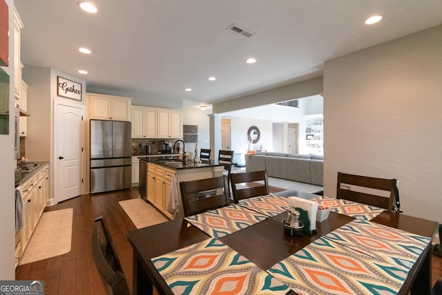 dining space with hardwood / wood-style floors and sink