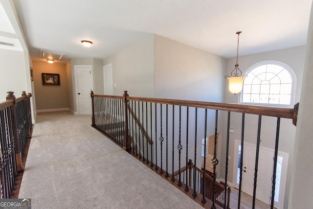 hallway featuring light colored carpet