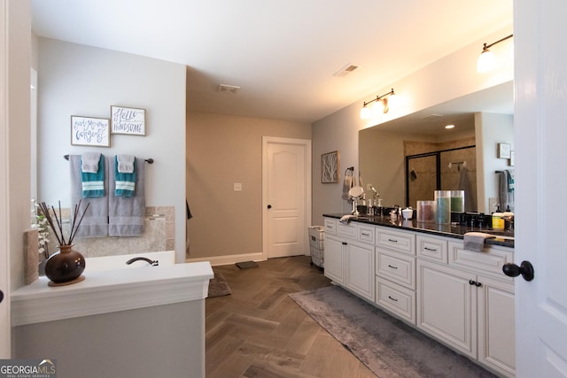 bathroom with parquet floors, vanity, and a shower with shower door