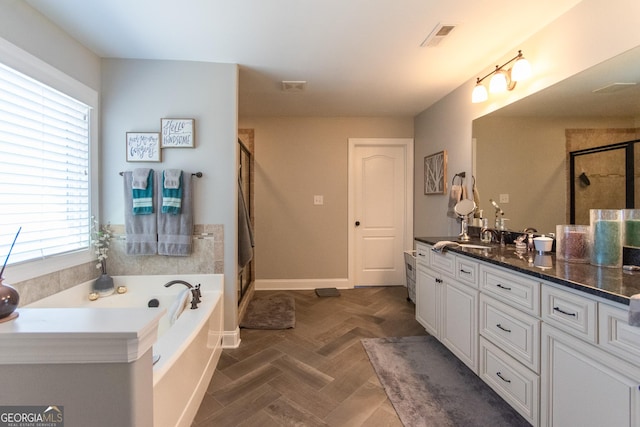 bathroom featuring separate shower and tub, a wealth of natural light, and vanity