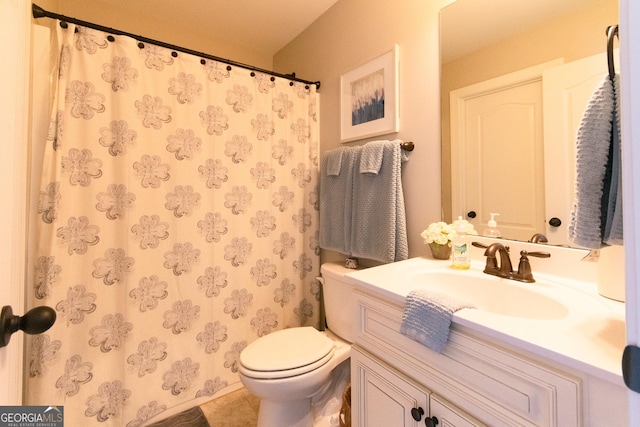 bathroom featuring tile patterned flooring, vanity, and toilet