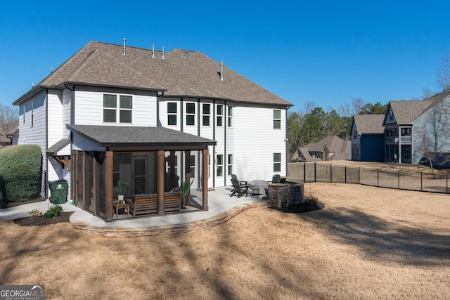 back of house with a sunroom and a patio