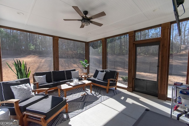 sunroom / solarium featuring ceiling fan