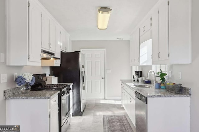 kitchen featuring appliances with stainless steel finishes, white cabinetry, and sink