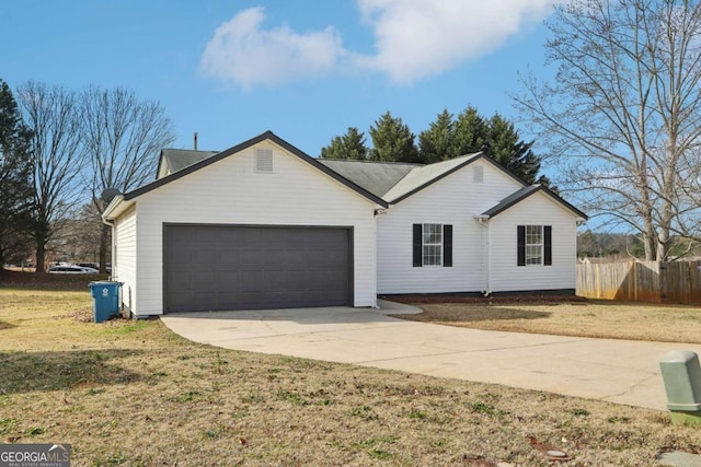 single story home featuring a front lawn and a garage