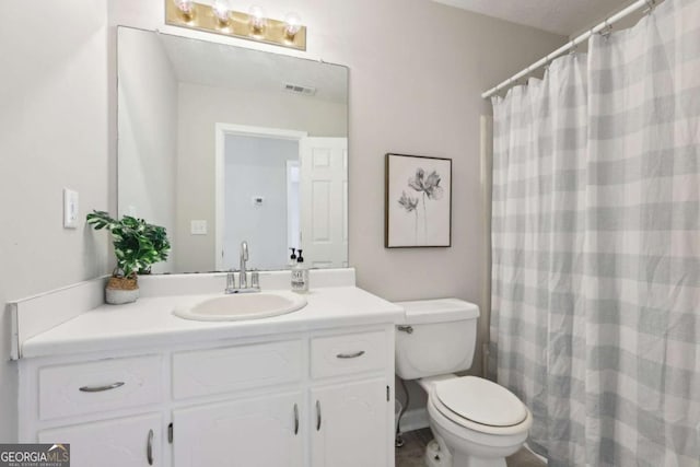 bathroom with a shower with shower curtain, vanity, toilet, and a textured ceiling