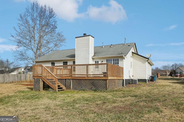 rear view of house with a lawn, central AC unit, and a deck