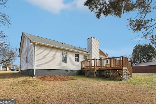 rear view of property with a lawn and a deck