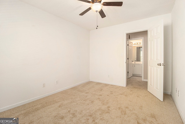 empty room featuring light carpet and ceiling fan