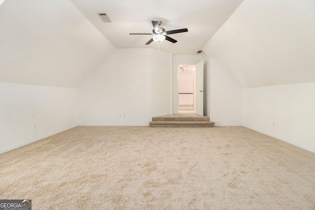 bonus room with carpet floors, ceiling fan, and vaulted ceiling