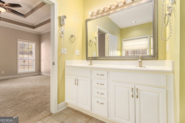 bathroom with crown molding, ceiling fan, tile patterned flooring, vanity, and a raised ceiling