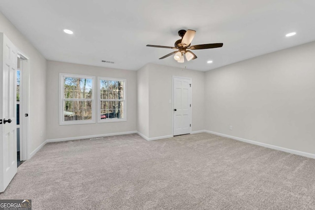 carpeted spare room with ceiling fan